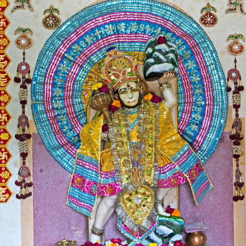 A large Hanuman idol carrying a mountain, representing his legendary feat of bringing the Sanjeevani herb to save Lakshman in the Ramayana.