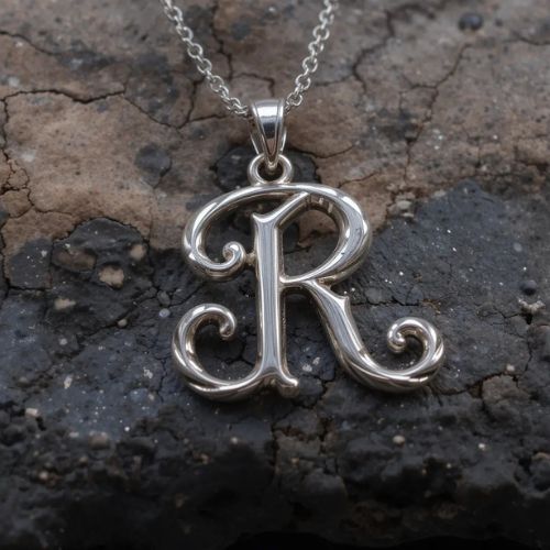 R DP Name ProProfileDP_ _The silver pendant holds the letter R, symbolizing love and elegance with its timeless charm