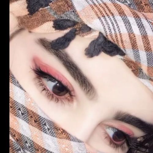 A stylish individual posing confidently in a trendy outfit, set against a chic urban backdrop.