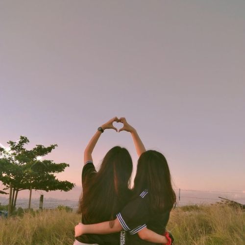 A group of friends enjoying a fun moment together, laughing and posing for the camera.