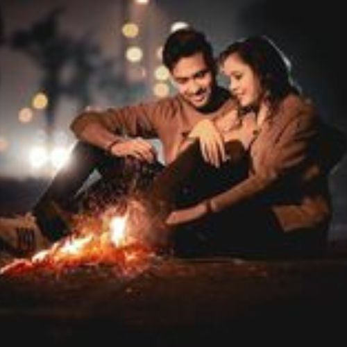 A couple sharing a special moment together, smiling and holding hands.