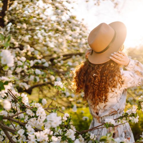 A girl standing gracefully among flowers, surrounded by nature's beauty – perfect Lifestyle DP.