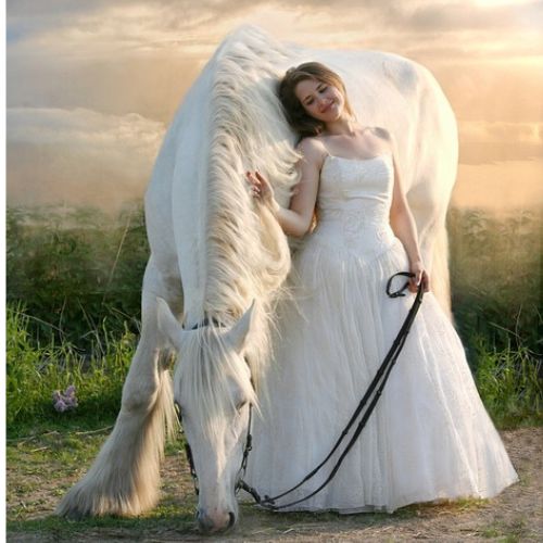 A woman with tousled brown hair, wrapped in a delicate knitted shawl, stands in a rugged outdoor landscape. Her soft gaze and crossed arms suggest a feeling of nostalgia or longing.