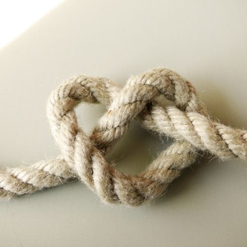 A close-up of a rope showing a prominent knot tied in the middle