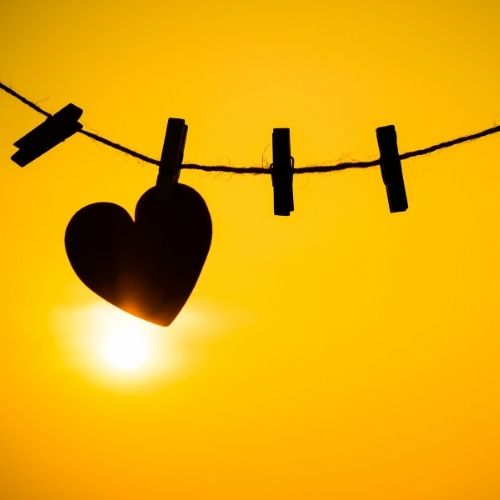 A heart-shaped cloth hangs on a clothesline