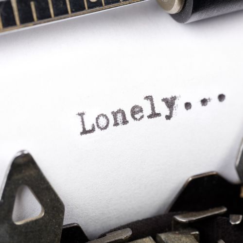 A solitary figure stands in a vast, empty landscape, evoking a sense of loneliness and isolation