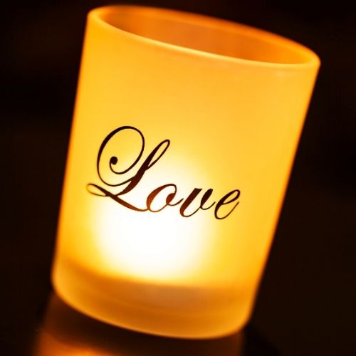 Elegant love-themed candle holder designed as a wedding favor