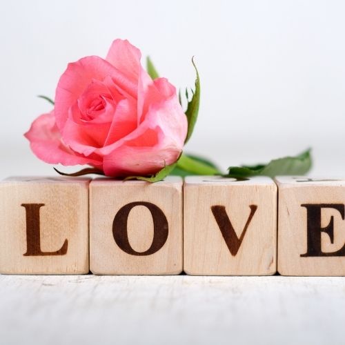 Wooden blocks arranged to spell the word love in a playful and colorful display
