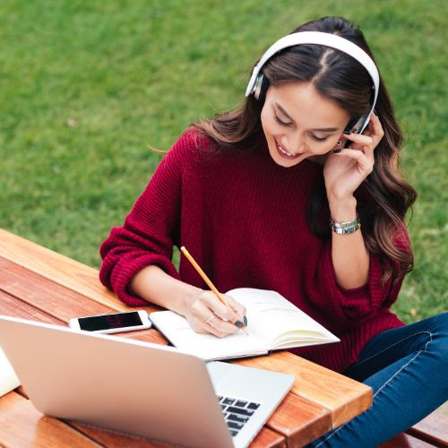 A young woman sits on a park bench