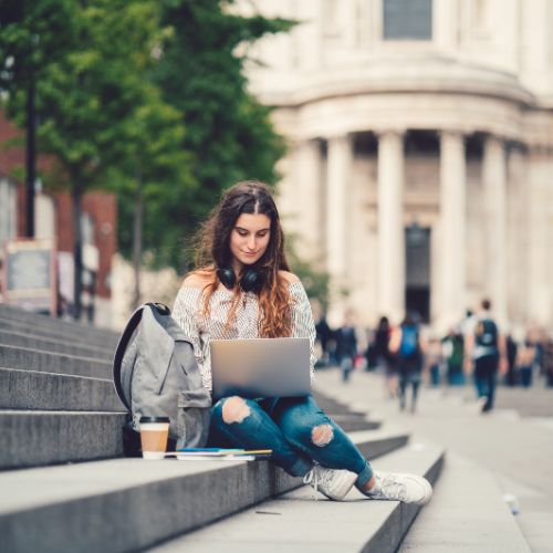 A young woman sitting on outdoor steps