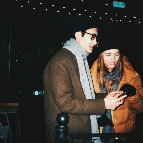 A man and woman stand in front of a building