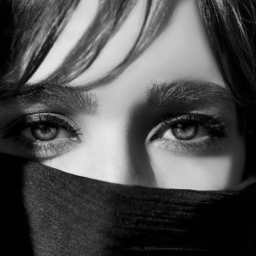 A woman with black eyes and a scarf covering her face