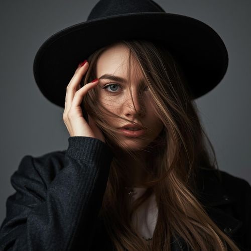 A woman with long hair wearing a stylish hat (3)