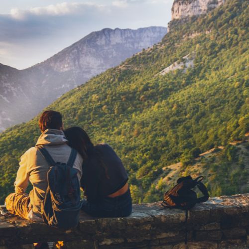 Couple sitting on a stone wal