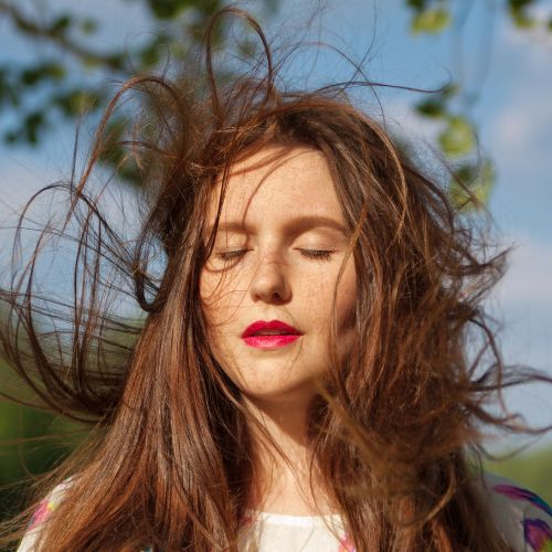 A woman with long hair flowing in the wind