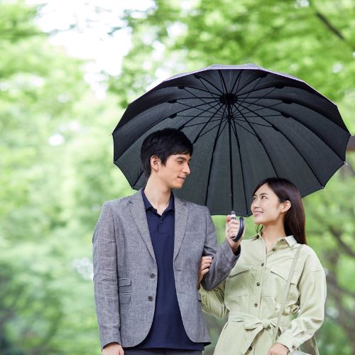 A young couple stands in a park